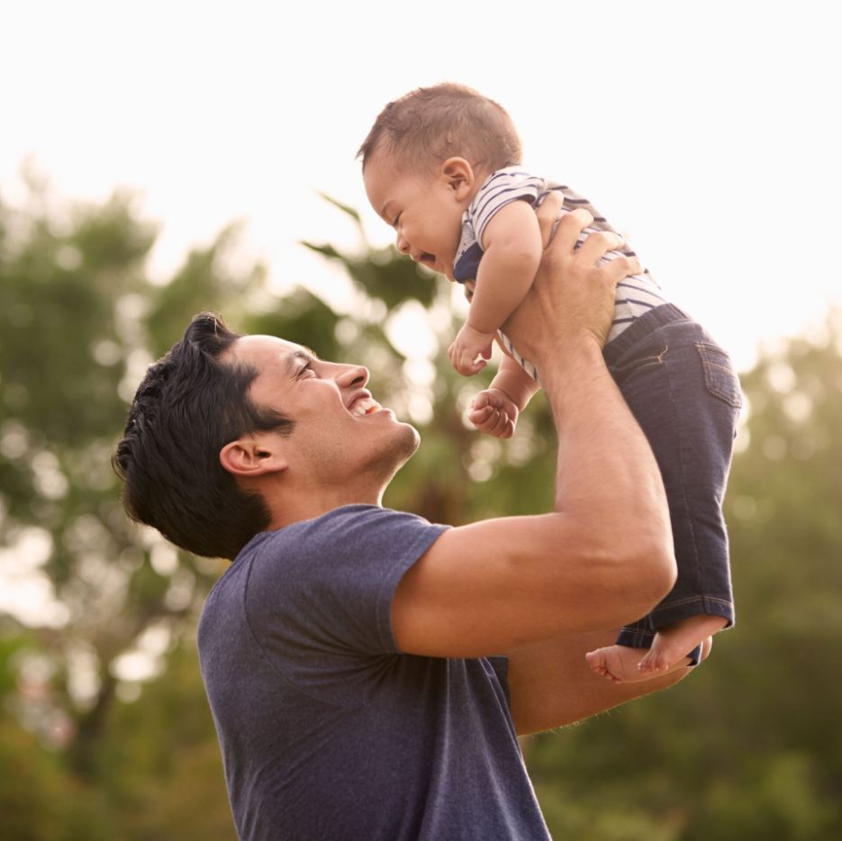 A father and baby looking into each other’s faces